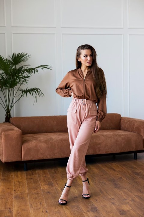 Virtual Try-On HD example output — the subject wearing the rust bomber from reference 1 and the pink satin pants from reference 2